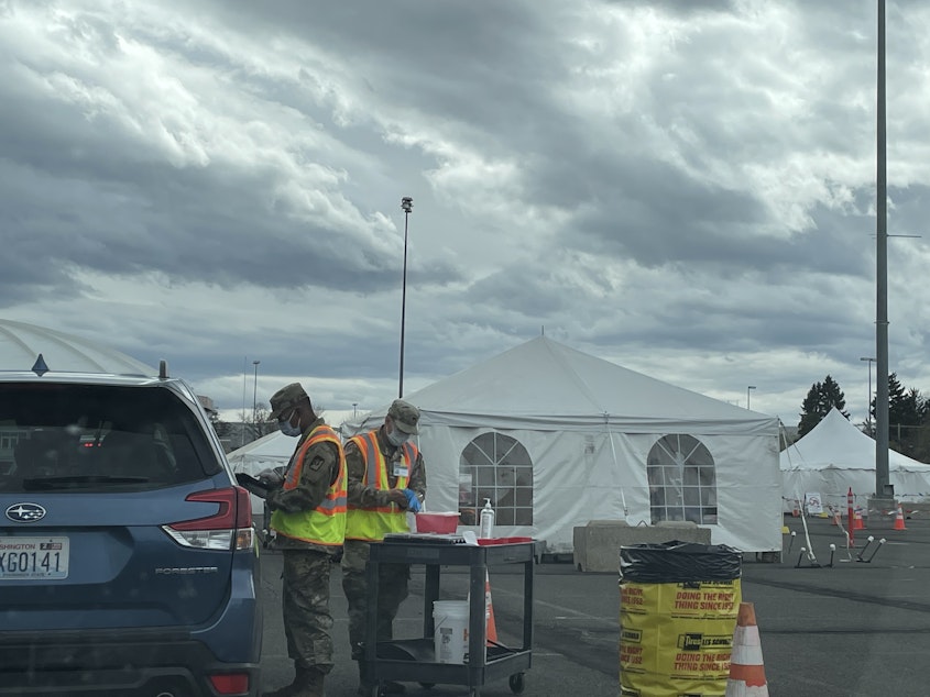 caption: Staff with the U.S. National Guard vaccinate people against Covid-19 in Yakima, WA on Easter Sunday 2021. The FEMA site is designed to vaccinate 1,200 people a day, with the potential to serve 3,000.