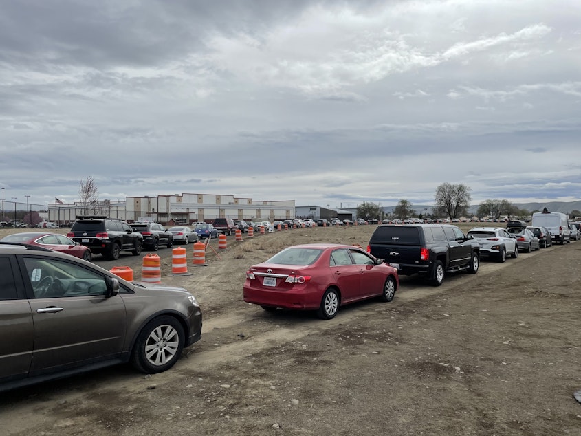 caption: Hundreds of cars wait in line at the FEMA mass vaccination site at the Yakima State Fair Park on April 4, 2021.