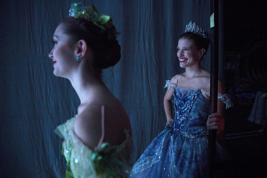 caption: Corps de ballet dancer Madison Rayn Abeo, left, and soloist Leah Merchant, right, stand backstage during the final scene of Cinderella on Saturday, February 1, 2020, at McCaw Hall in Seattle.