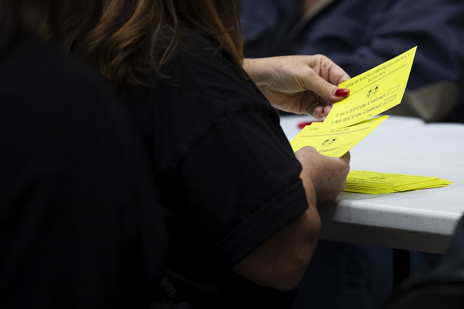 caption: Union members count votes from striking Boeing machinists on whether to accept or reject the latest contract offer from Boeing on Wednesday, October 23, 2024, at IAM Hall in Seattle.